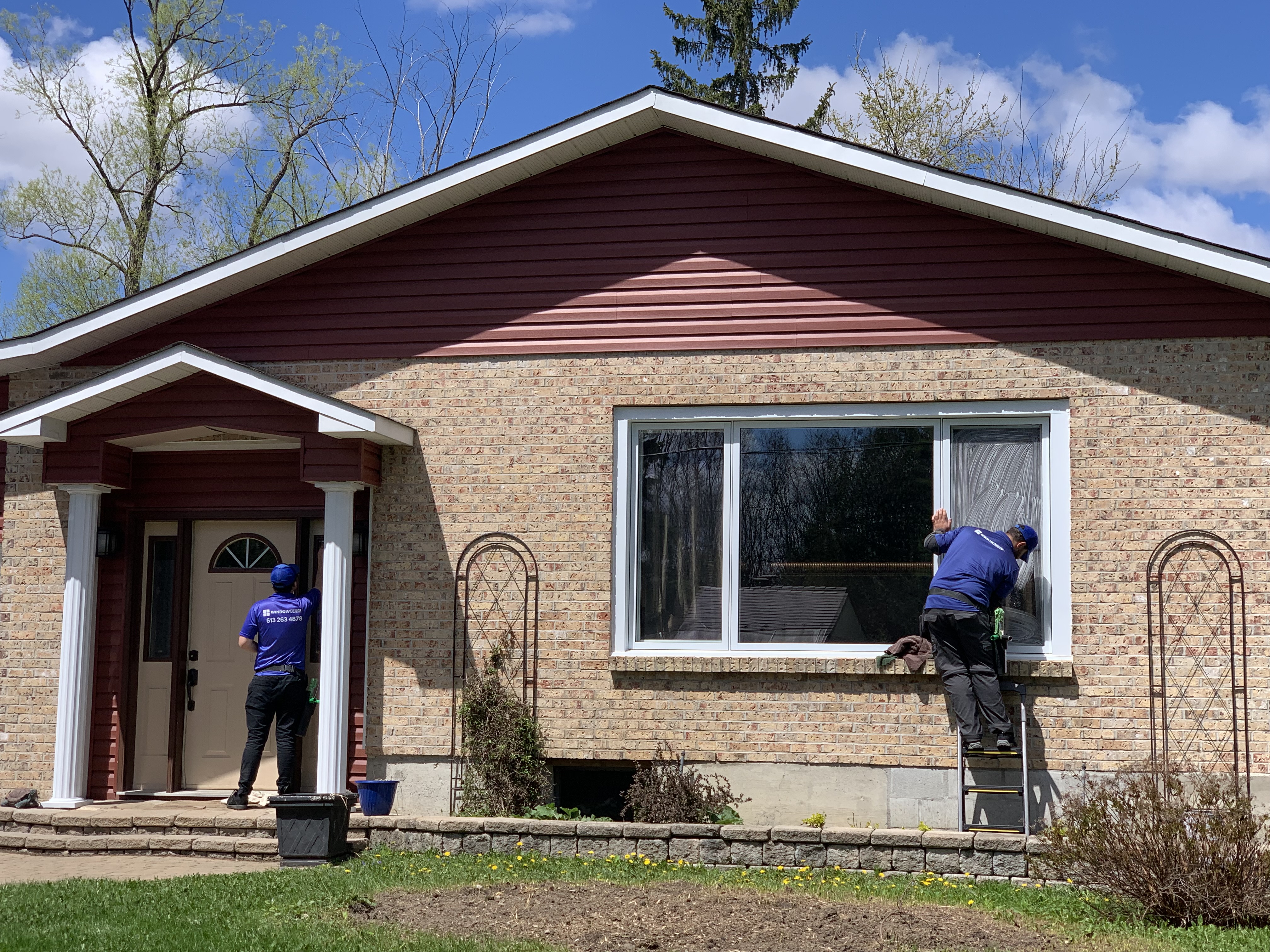 WindowGuru team providing siding cleaning services